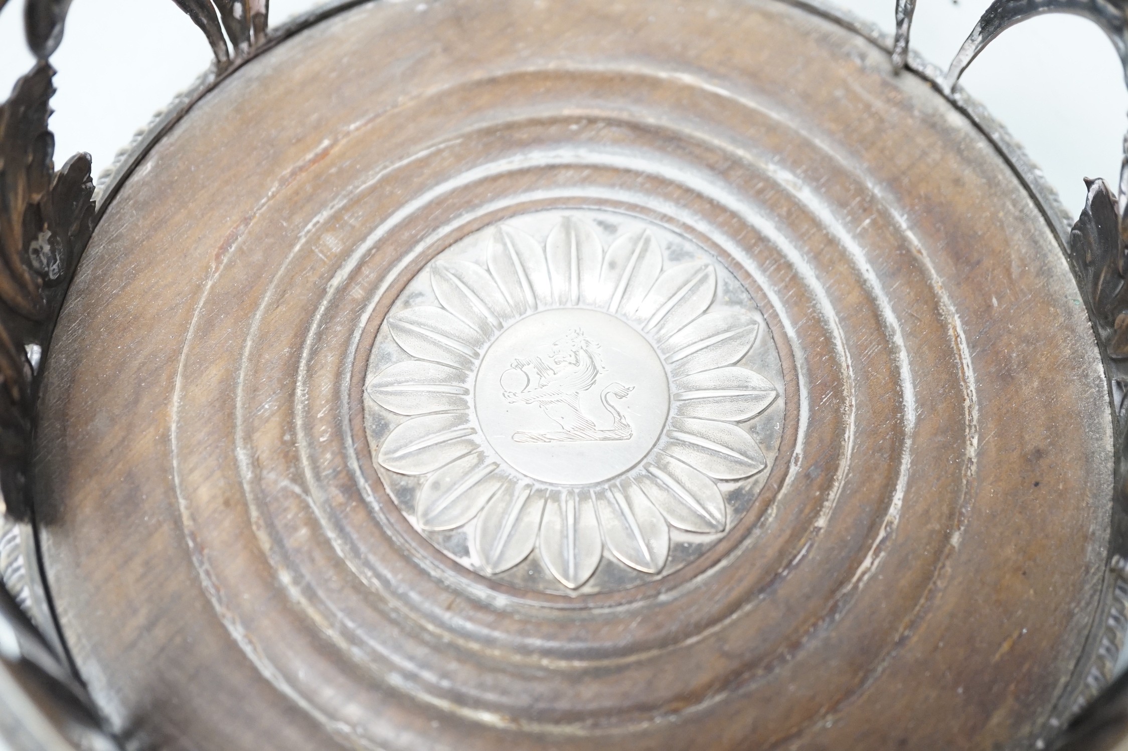 An early 19th century silver mounted wine coaster, marks rubbed, 14cn.